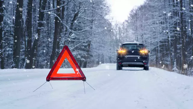 Warning triangle by car in snow