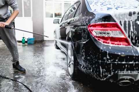 Use a pressure washer to remove loose dirt Using a pressure washer to clean a car