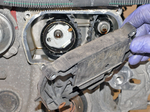 The timing belt is usually hidden behind a cover Timing belt cover being removed