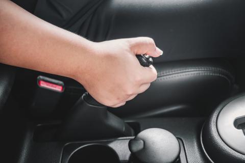 Handbrake pulling up too high? It needs to be adjusted Handbrake being applied in a car