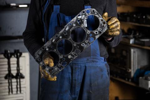 Head gasket repairs are less complex than you might imagine Head gasket being held by a mechanic