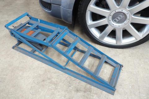 Choose the right car ramps for your car A car ramp next to a car