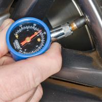 A tyre pressure gauge being used