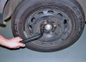 Loosen the nuts on the flat tyre