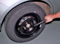 Lower the vehicle and tighten the nuts